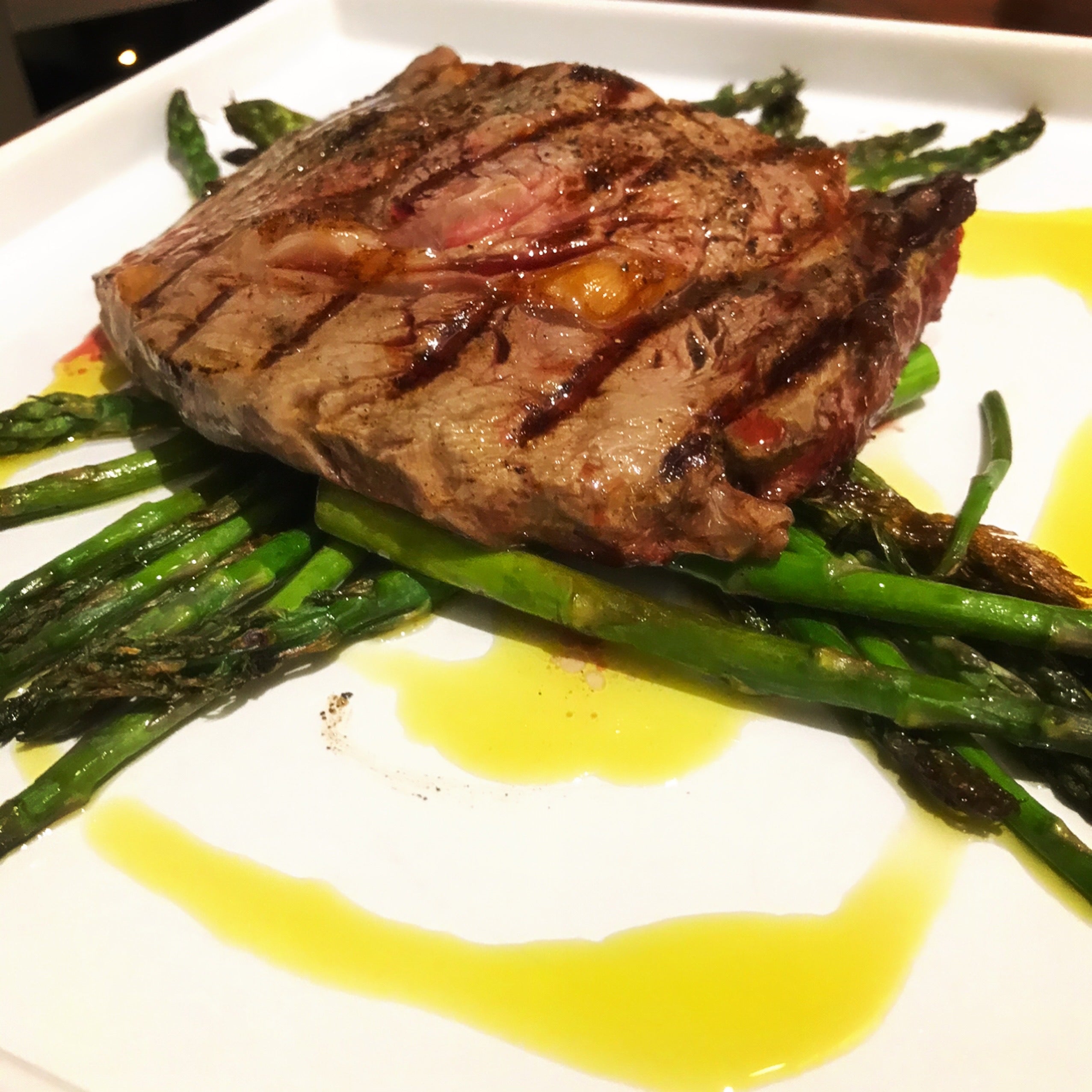 A huge steak and a generous amount of fresh olive oil!